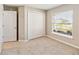 Bedroom featuring a double door closet, a window, and neutral carpet at 5996 Wildflower Field Way, St Cloud, FL 34771