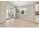 Bright dining area with sliding glass doors to the backyard and modern lighting fixture at 5996 Wildflower Field Way, St Cloud, FL 34771