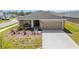 Charming single-Gathering home with a two car garage, walkway, and landscaping at 5996 Wildflower Field Way, St Cloud, FL 34771