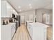 Spacious kitchen with white cabinets, an island and stainless steel appliances at 5996 Wildflower Field Way, St Cloud, FL 34771