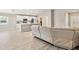 Open floorplan with a large couch, updated kitchen with an island, stainless steel appliances, and white cabinets at 5996 Wildflower Field Way, St Cloud, FL 34771