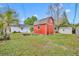 Backyard with green grass, a red shed, and additional storage sheds at 6373 Forecastle Ct, Orlando, FL 32807