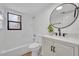 Clean bathroom with white tile, updated vanity, and a shower and tub at 6373 Forecastle Ct, Orlando, FL 32807