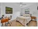 Bright bedroom features wood flooring, neutral colors, and natural light from two windows at 6373 Forecastle Ct, Orlando, FL 32807