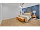 Stylish bedroom with a blue accent wall, ceiling fan, and modern decor at 6373 Forecastle Ct, Orlando, FL 32807