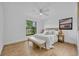 Airy bedroom features a ceiling fan, wood floors, natural light, and a bench at 6373 Forecastle Ct, Orlando, FL 32807