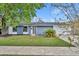 Inviting single-story home with blue brick, neat landscaping, and attached two-car garage on a sunny day at 6373 Forecastle Ct, Orlando, FL 32807