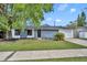 Attractive one-story home with well-kept lawn, blue brick facade, and attached garage on a bright, sunny day at 6373 Forecastle Ct, Orlando, FL 32807
