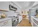 Open kitchen with stainless appliances, white cabinets, and an adjacent dining area at 6373 Forecastle Ct, Orlando, FL 32807