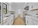 Updated kitchen showcasing stainless appliances, white cabinets, and stylish backsplash at 6373 Forecastle Ct, Orlando, FL 32807