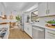 Well-lit kitchen with stainless steel appliances, white cabinets, and modern fixtures at 6373 Forecastle Ct, Orlando, FL 32807