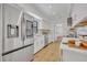 Bright kitchen features stainless steel appliances, white cabinets, and modern countertops at 6373 Forecastle Ct, Orlando, FL 32807