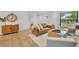 Bright living room showcasing hardwood floors, stylish leather sofa, and ample natural light through a large window at 6373 Forecastle Ct, Orlando, FL 32807