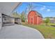 A large red barn-style shed is located in the backyard with a concrete patio at 6373 Forecastle Ct, Orlando, FL 32807