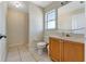 Bright bathroom with a walk-in shower, toilet, cabinet sink, and a large mirror at 68 Herring Ct, Kissimmee, FL 34759