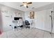 Bedroom with neutral walls, light tile, ceiling fan, and a large closet at 68 Herring Ct, Kissimmee, FL 34759