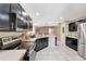 Well-lit kitchen showcasing modern appliances, dark cabinetry, tile floors, and ample counter space at 68 Herring Ct, Kissimmee, FL 34759