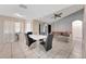 Open-concept dining and living area, featuring tiled flooring, ceiling fan, and natural light at 68 Herring Ct, Kissimmee, FL 34759