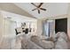 Living area with tiled flooring, ceiling fan, modern furniture, flowing into an open floor plan at 68 Herring Ct, Kissimmee, FL 34759