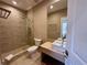 Contemporary bathroom featuring neutral herringbone tile, glass shower, and vessel sink at 7534 Brooklyn Dr, Kissimmee, FL 34747