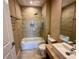 Bathroom featuring neutral tile, shower-tub, granite vanity, and recessed lighting at 7534 Brooklyn Dr, Kissimmee, FL 34747