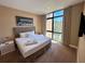 Bedroom featuring large window, upholstered headboard, neutral color palette, and city skyline art at 7534 Brooklyn Dr, Kissimmee, FL 34747