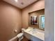 Stylish half bathroom featuring a modern vanity, contemporary fixtures, and elegant decor at 7534 Brooklyn Dr, Kissimmee, FL 34747