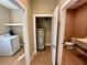 Hallway showcasing the laundry room, hot water tank closet and half bathroom at 7534 Brooklyn Dr, Kissimmee, FL 34747