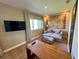 Cozy living room featuring neutral sofa, mounted television, and natural light at 7534 Brooklyn Dr, Kissimmee, FL 34747