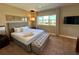 Comfortable main bedroom featuring a king bed, neutral decor, and an exterior view from the window at 7534 Brooklyn Dr, Kissimmee, FL 34747