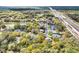 Scenic aerial view showcases a neighborhood with mature trees, a pond, and easy highway access at 8176 Emerald Forest Ct, Sanford, FL 32771