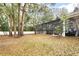 Spacious backyard with mature trees and an enclosed pool with clear views to the pool area at 8176 Emerald Forest Ct, Sanford, FL 32771