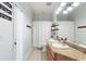 Bright bathroom featuring double sinks, granite countertops, and neutral tile flooring at 8176 Emerald Forest Ct, Sanford, FL 32771