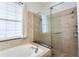 Bright bathroom featuring a soaking tub with a separate glass-enclosed shower at 8176 Emerald Forest Ct, Sanford, FL 32771