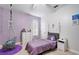 Cozy bedroom featuring a plush rug, accent wall, and ample natural light at 8176 Emerald Forest Ct, Sanford, FL 32771