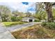 Well-maintained single-story home with a side-entry garage, basketball hoop, and a lush green lawn at 8176 Emerald Forest Ct, Sanford, FL 32771