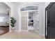 Spacious foyer showcasing French doors, black front door, and arched doorway at 8176 Emerald Forest Ct, Sanford, FL 32771