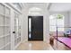Bright foyer featuring tile flooring, elegant front door, and glass paneled doors at 8176 Emerald Forest Ct, Sanford, FL 32771