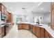 Open kitchen layout with a view of the living room, stainless steel appliances, and ample counter space at 8176 Emerald Forest Ct, Sanford, FL 32771