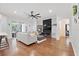 Open living room with modern decor, fireplace, hardwood floors, and sliding glass doors at 8176 Emerald Forest Ct, Sanford, FL 32771