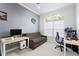Bright office space featuring a large window, neutral walls, and modern furniture at 8176 Emerald Forest Ct, Sanford, FL 32771