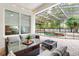 Inviting covered patio with outdoor seating overlooking a fenced swimming pool and landscaped backyard at 8176 Emerald Forest Ct, Sanford, FL 32771