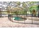 Enclosed pool area features a custom pool and hot tub, all surrounded by a secure safety fence at 8176 Emerald Forest Ct, Sanford, FL 32771