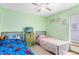 The bedroom has light green walls, carpeted floors, two beds and a ceiling fan at 835 Longleaf Pine Ct, Orlando, FL 32825