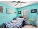 The bedroom has blue walls, carpeted floors, a loveseat and a ceiling fan at 835 Longleaf Pine Ct, Orlando, FL 32825