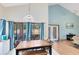 Bright dining area featuring a pendant light fixture, and seamless connection to the screened in patio at 835 Longleaf Pine Ct, Orlando, FL 32825