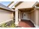 Inviting front porch with brick pavers and decorative columns, enhanced by a charming welcome sign at 835 Longleaf Pine Ct, Orlando, FL 32825