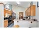Efficient kitchen featuring modern stainless appliances, wood cabinetry, and breakfast bar at 835 Longleaf Pine Ct, Orlando, FL 32825