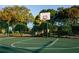 Outdoor basketball court surrounded by trees and a fence on a sunny day at 8837 Latrec Ave # 5307, Orlando, FL 32819