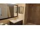 Bathroom with updated vanity, mirror and tiled shower at 8837 Latrec Ave # 5307, Orlando, FL 32819